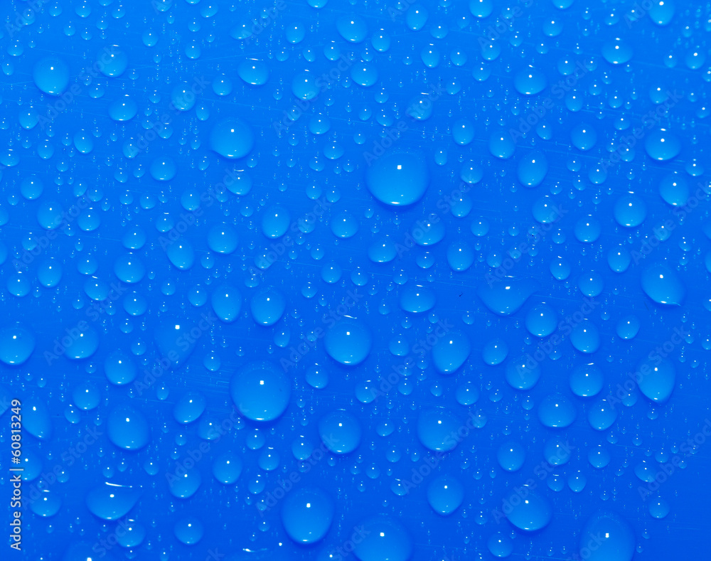 Drops of water on a blue background. Macro