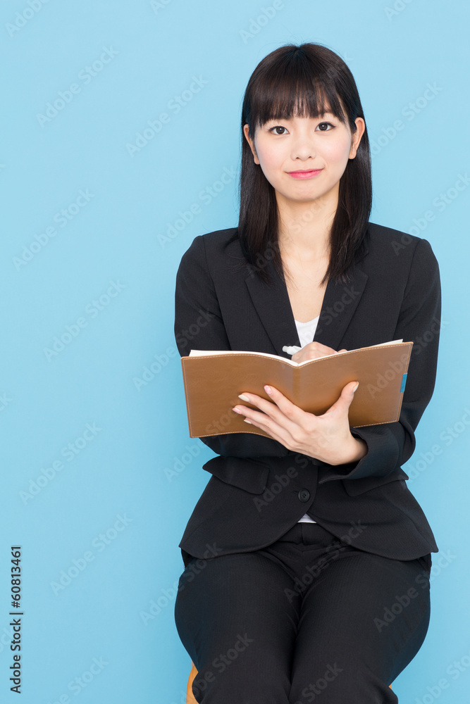 asian businesswoman interviewing on blue background asian businesswoman interviewing on blue background