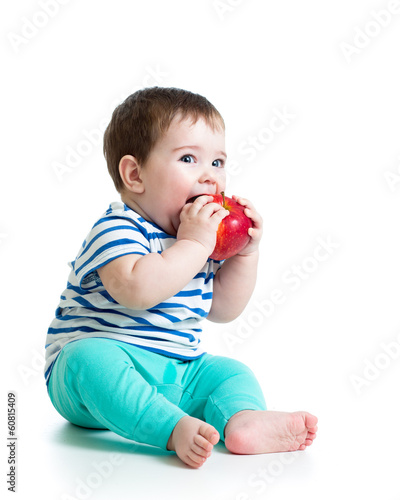 Baby boy eating red apple, ...