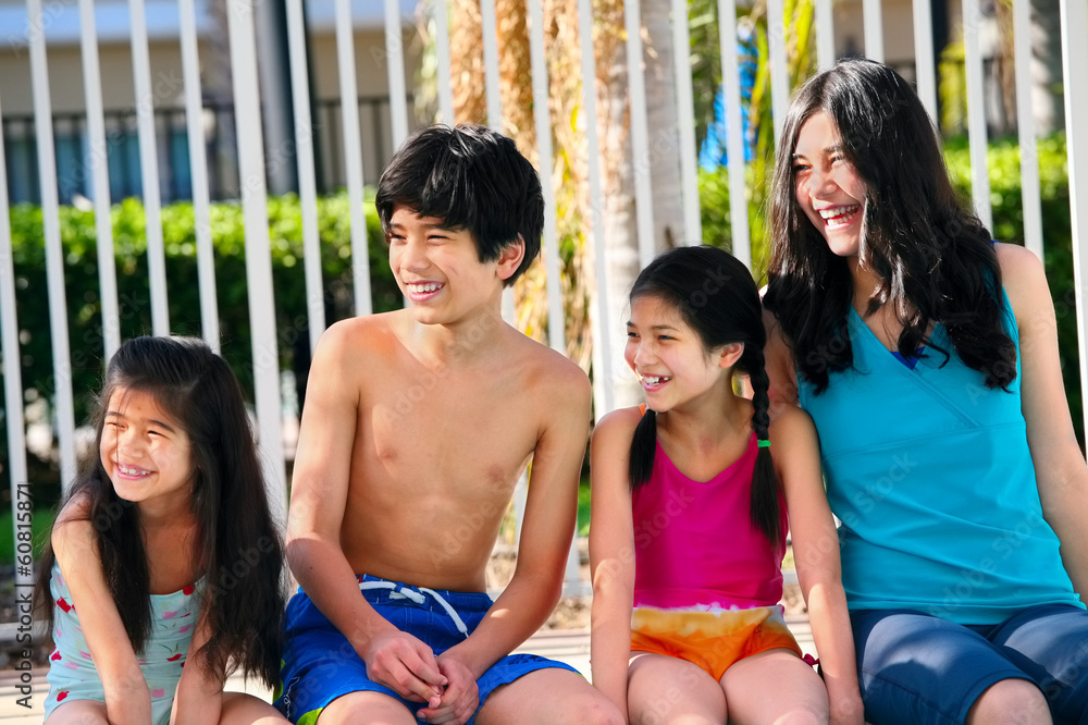 Fototapeta premium Four children by the pool side