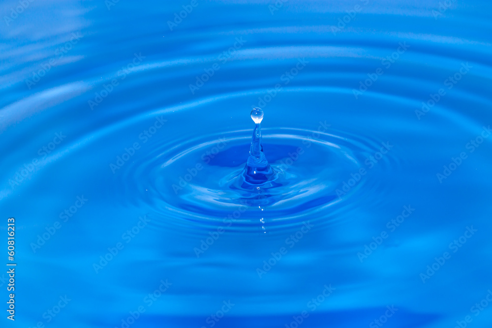 abstract background. drop falls in blue water abstract background. drop falls in blue water