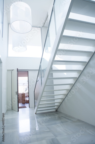 Modern white house entrance hall lobby with stairway