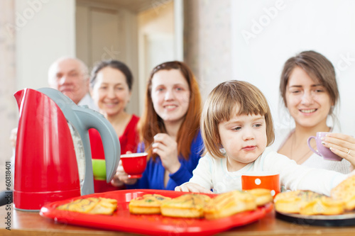 Portrait of   family communicate around tea