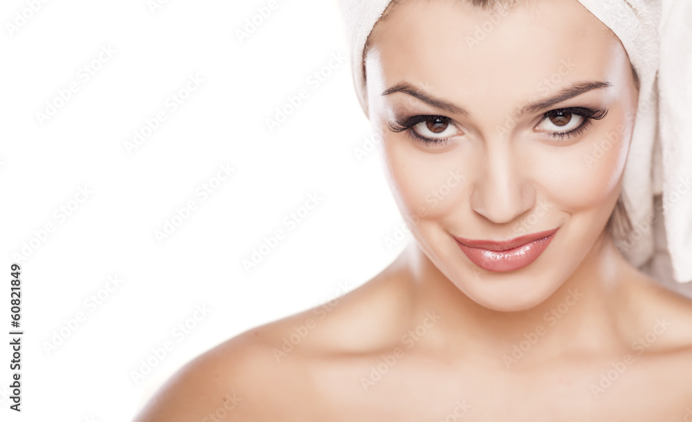 smiling beautiful girl with a towel on her head posing on white smiling beautiful girl with a towel on her head posing on white