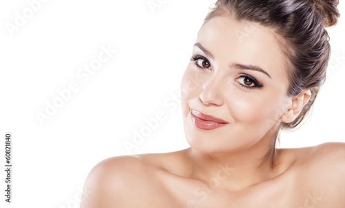 smiling beautiful girl with bun posing on a white background
