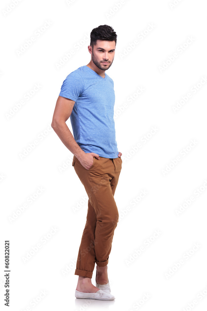 young man standing with his legs crossed young man standing with his legs crossed