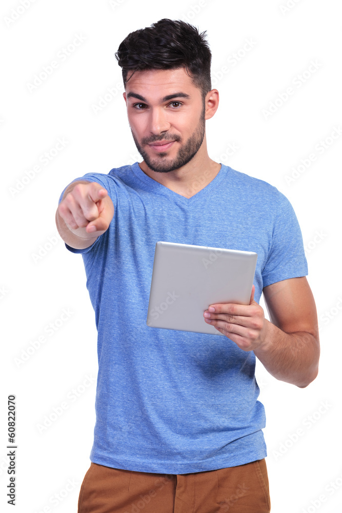 casual man reading on a tablet pad is pointing casual man reading on a tablet pad is pointing