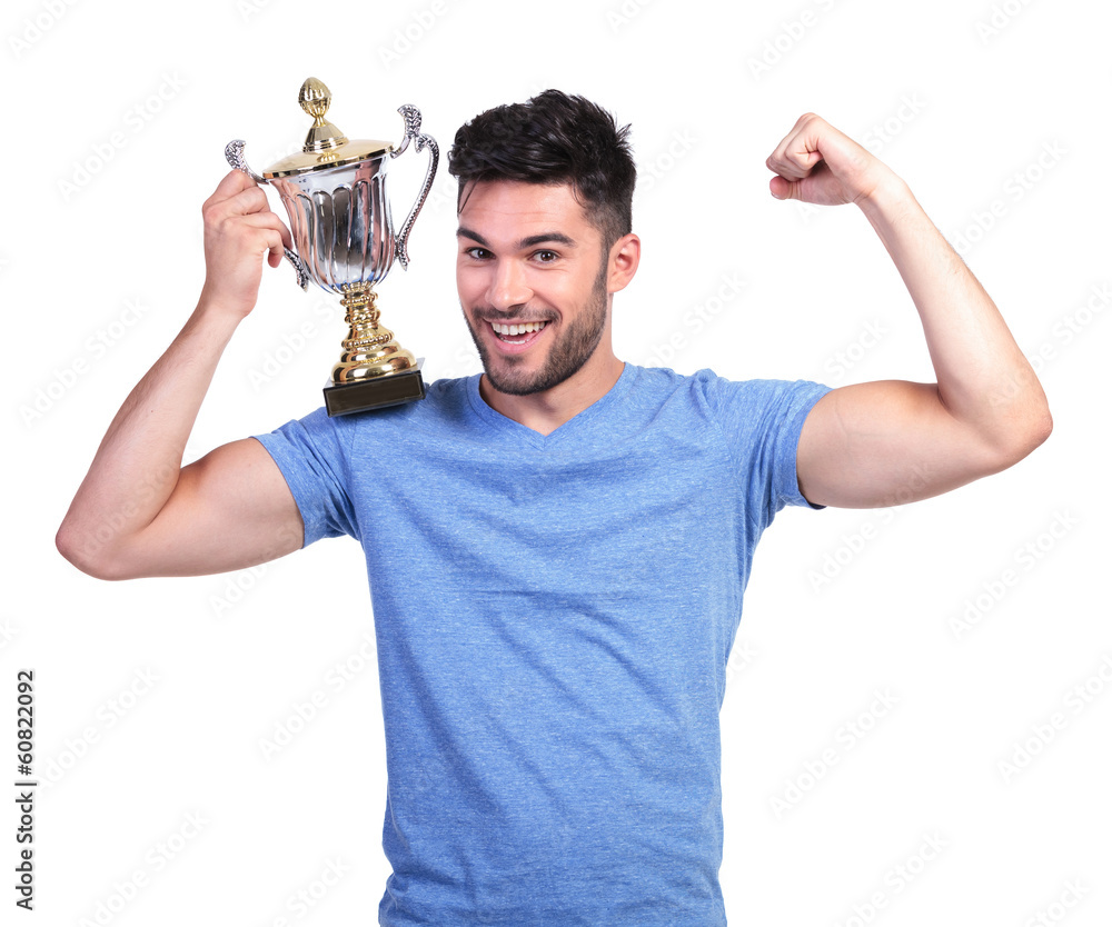 man flexing his muscle and holding a trophy cup