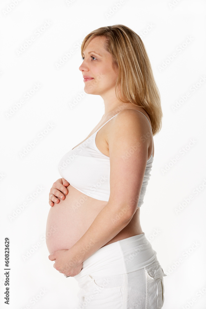 Studio Portrait Of 6 months Pregnant Woman Wearing White Studio Portrait Of 6 months Pregnant Woman Wearing White