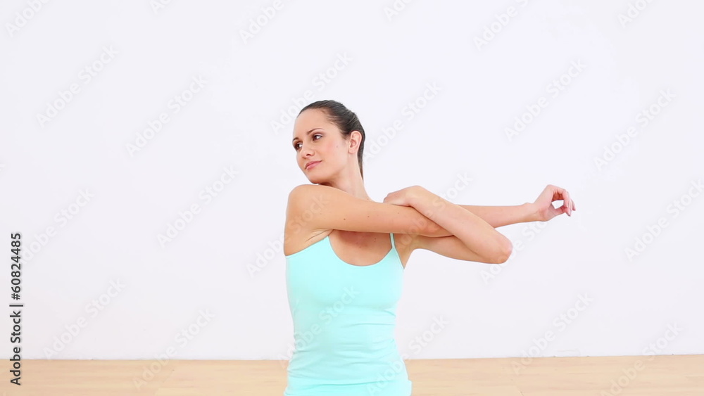Fit model stretching her arms and smiling at camera Fit model stretching her arms and smiling at camera