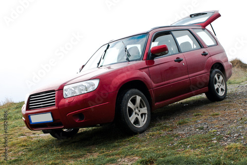 Red SUV on mountain road