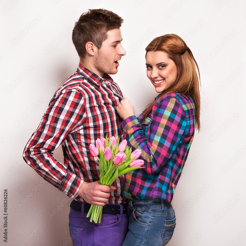 Young couple in love holding a bouquet of tulips. Young couple in love holding a bouquet of tulips.