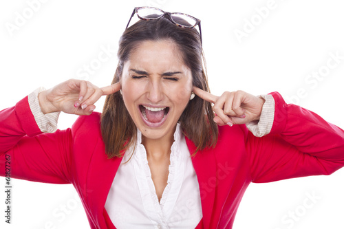 Portrait of a unhappy young woman covering her ears and screamin