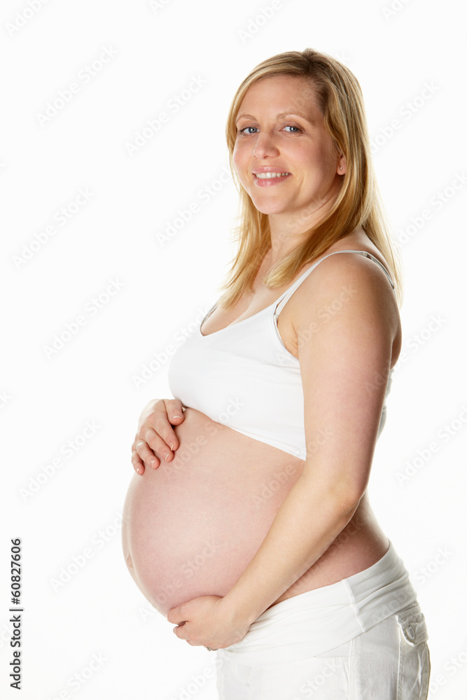 Studio Portrait Of 8 Months Pregnant Woman Wearing White Studio Portrait Of 8 Months Pregnant Woman Wearing White