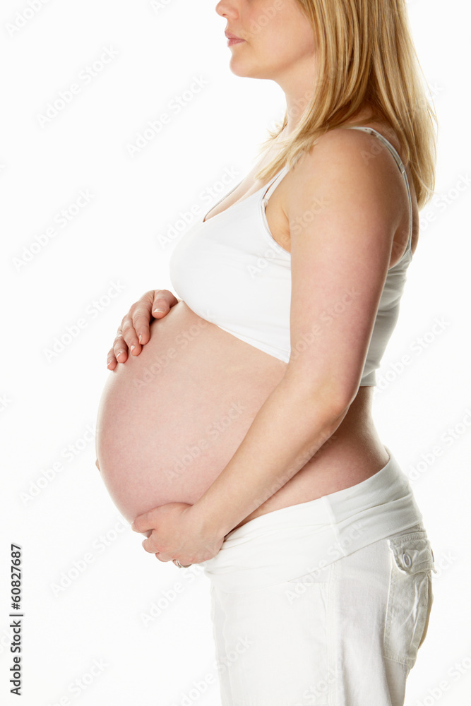 Close Up Studio Portrait Of 8 Months Pregnant Woman Wearing Whit Close Up Studio Portrait Of 8 Months Pregnant Woman Wearing Whit