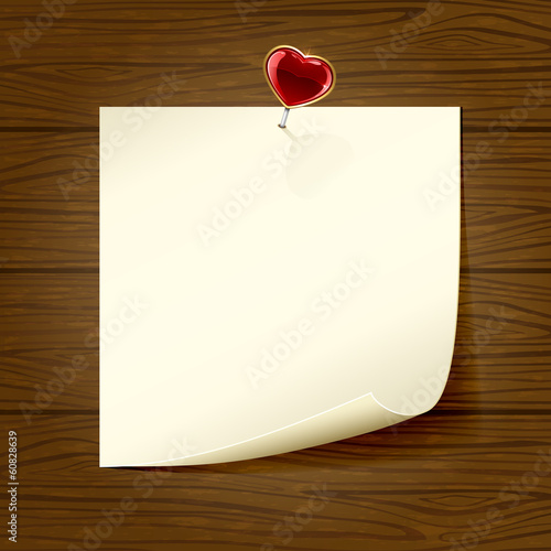 Paper and heart on wooden background