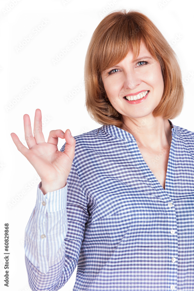 Smiling mature woman gesturing an excellent job sign Smiling mature woman gesturing an excellent job sign