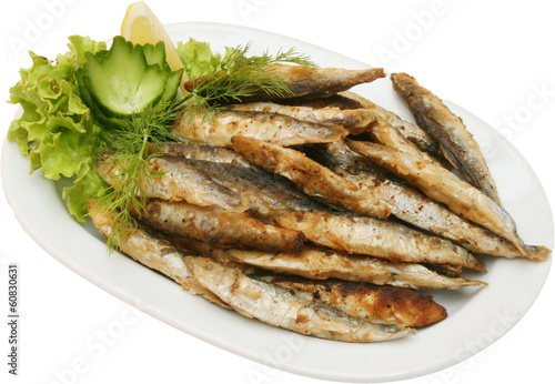 Grilled small fishes on BBQ with vegetables 