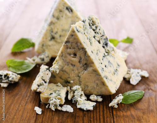 Wallpaper Mural Tasty blue cheese with basil, on wooden table Torontodigital.ca