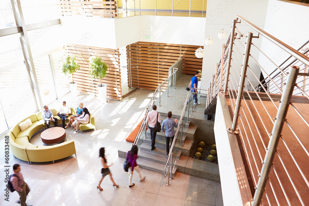 Reception Area Of Modern Office Building With People