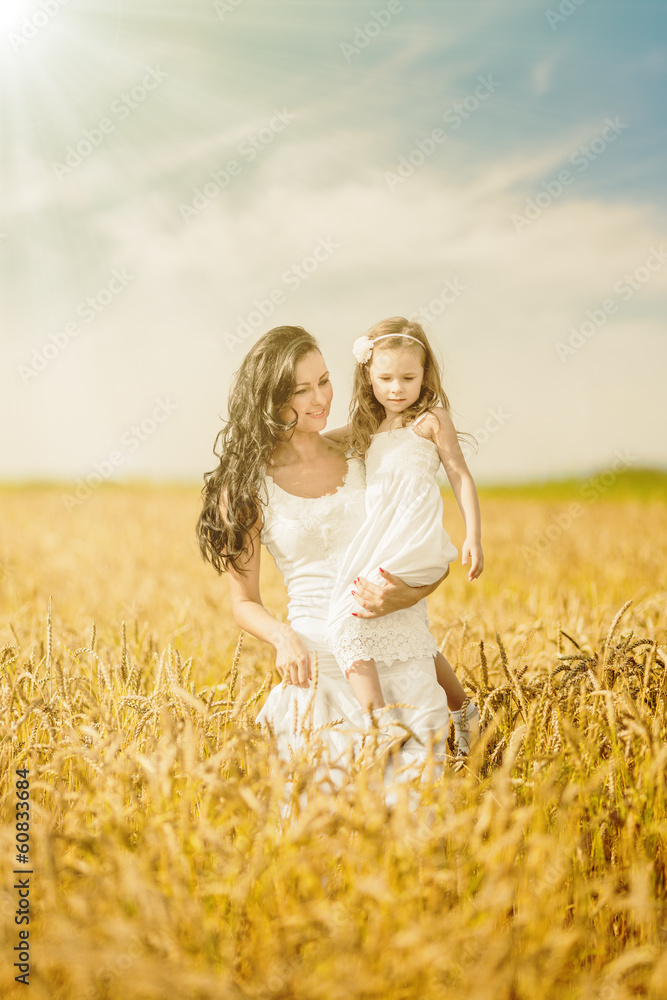 Mother and daughter among wheat ears Mother and daughter among wheat ears
