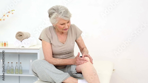 Injured patient rubbing her painful knee