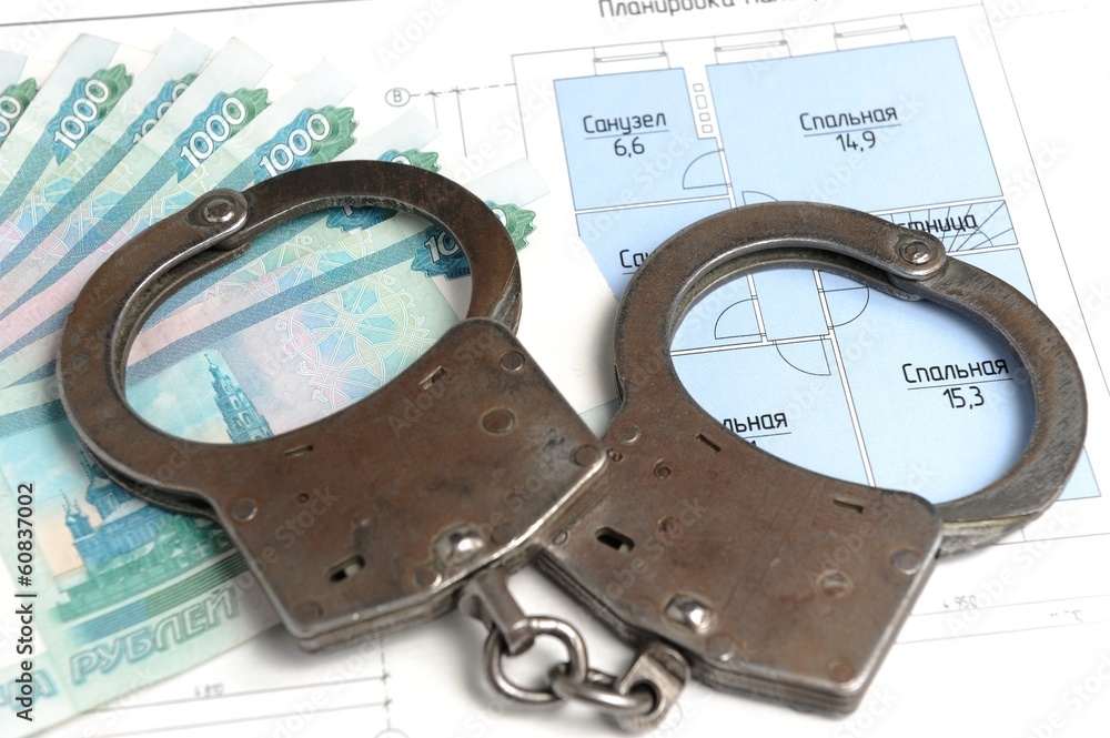 Handcuffs, money with the plan of the house isolated Handcuffs, money with the plan of the house isolated
