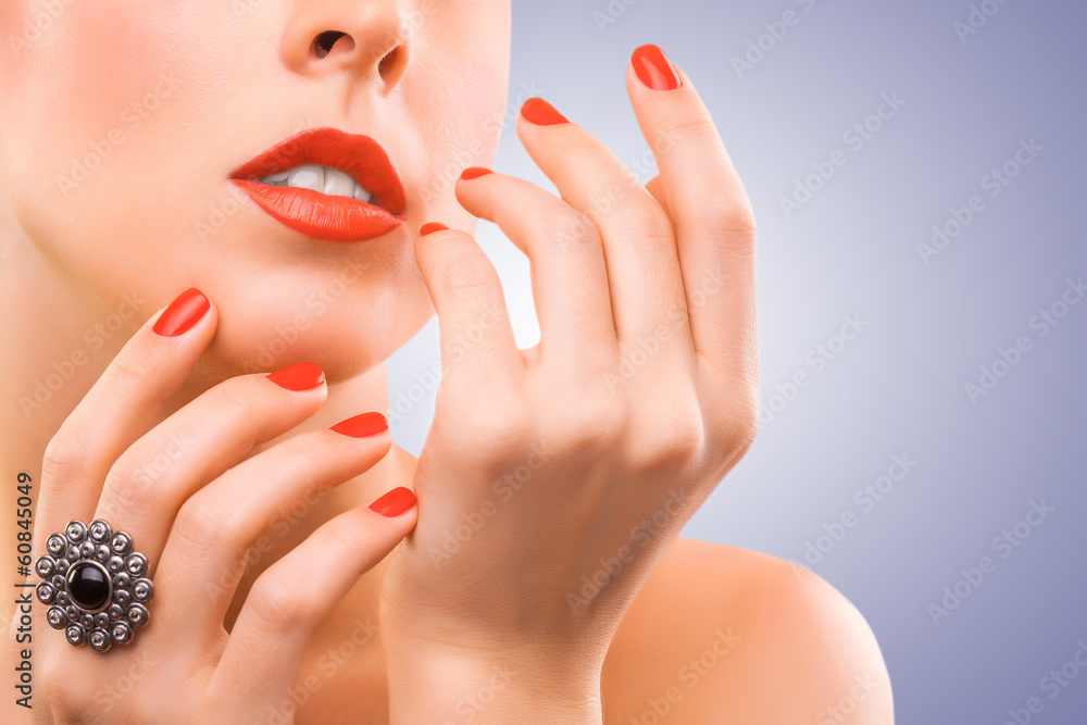 face and beautiful red manicure on the blue face and beautiful red manicure on the blue