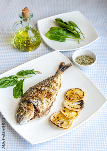 Grilled dorada fish with lemon and spinach