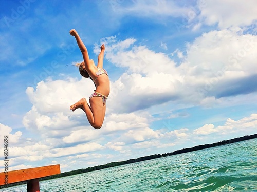 Girl jumping into the lake.