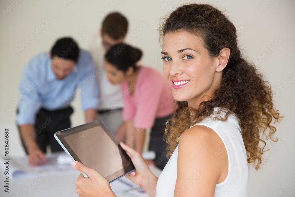 Confident businesswoman holding digital tablet Confident businesswoman holding digital tablet
