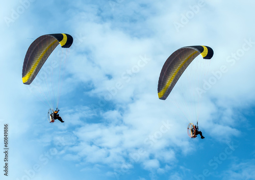 Paragliding fly on blue sky