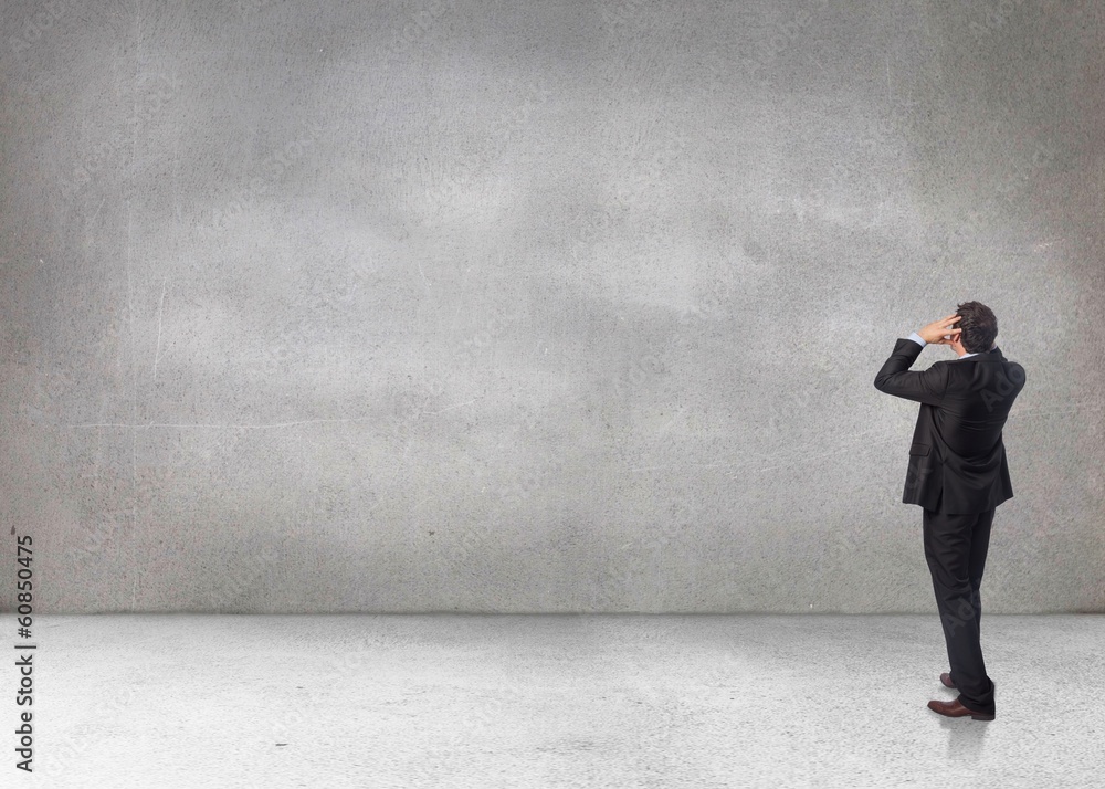Composite image of stressed businessman with hands on head Composite image of stressed businessman with hands on head