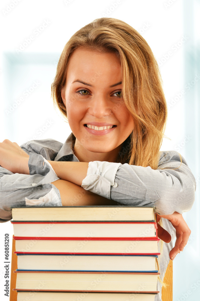 Female student with books in the library Female student with books in the library