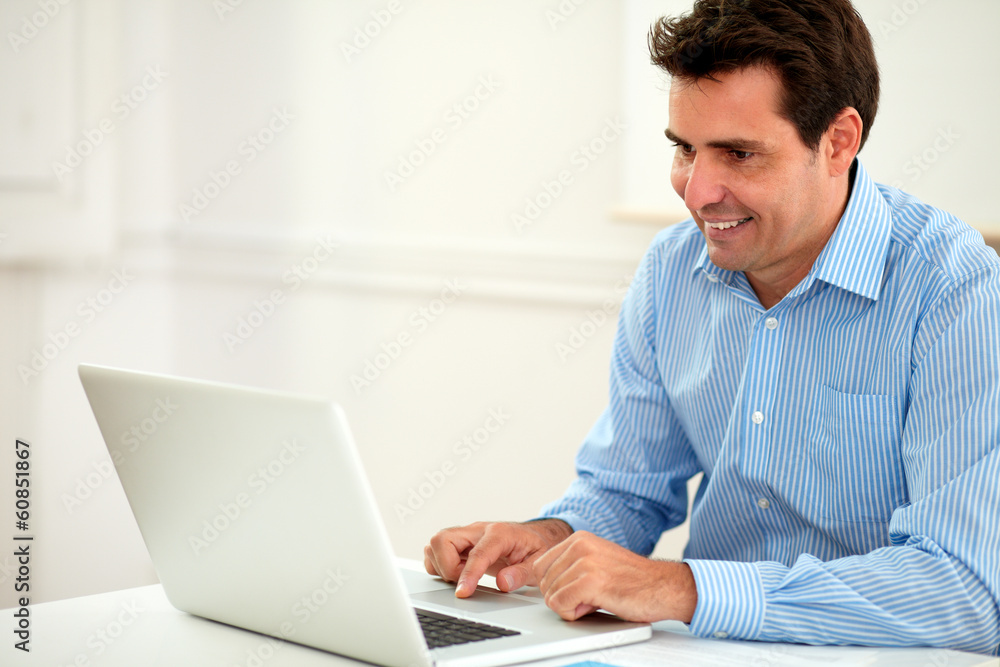 Alone adult businessman working on his laptop Alone adult businessman working on his laptop