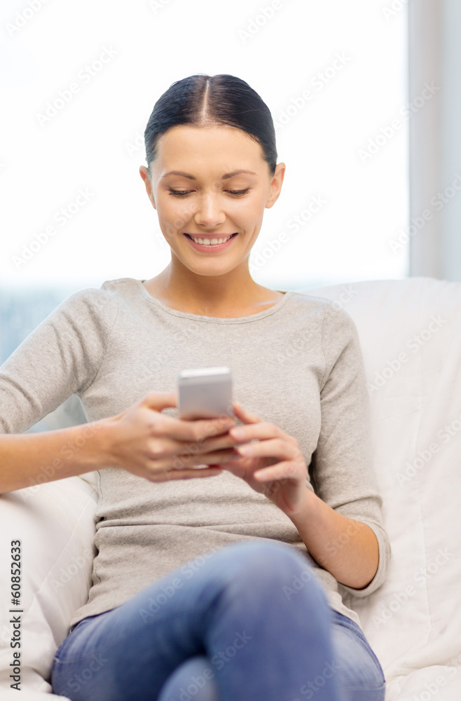 smiling woman with smartphone at home smiling woman with smartphone at home