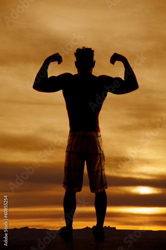 silhouette wet man muscles flex both arms up photo