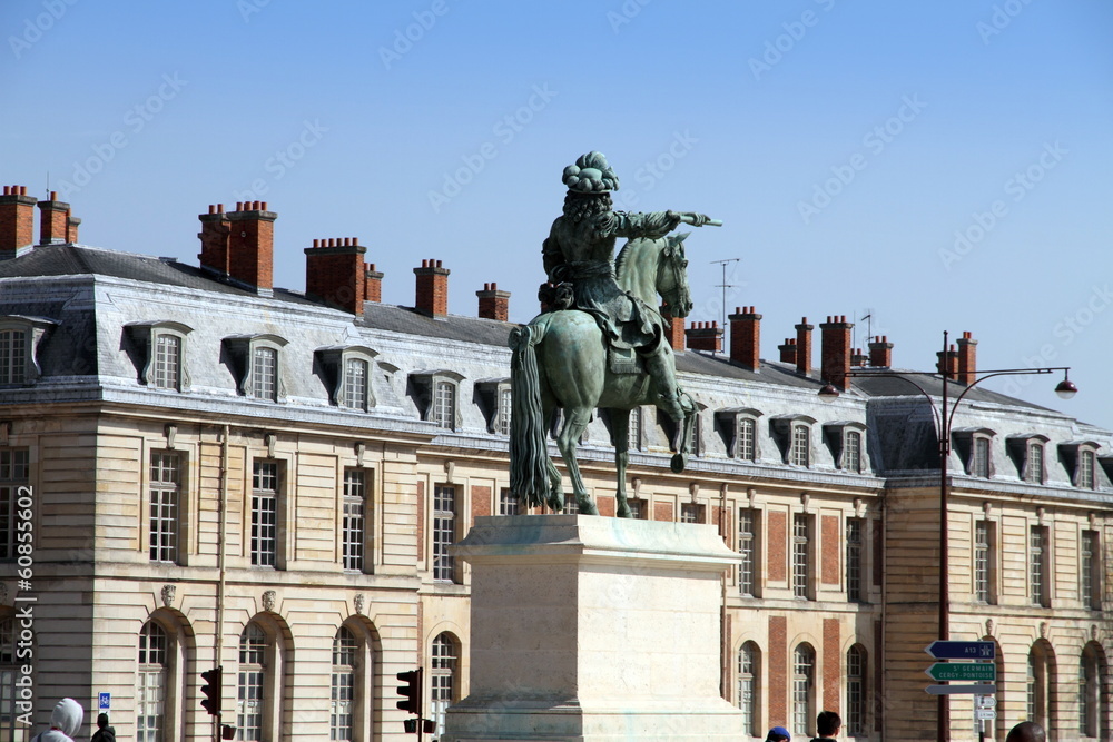 Equestrian statue of the king Louis opposite Versailles palace F