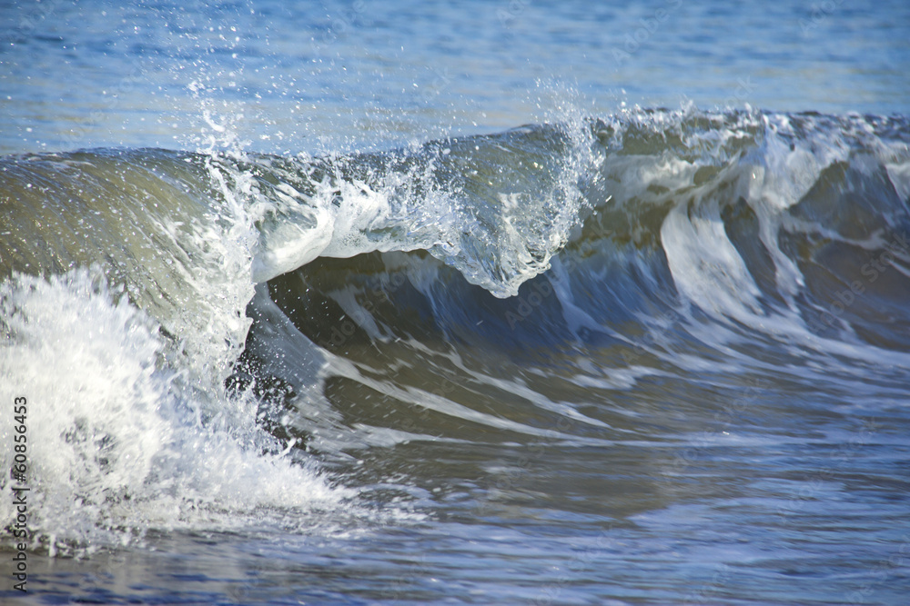 Blue breaking curled shorebreak wave Blue breaking curled shorebreak wave