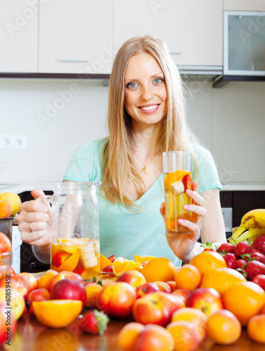 cheerful woman with fruits beverage