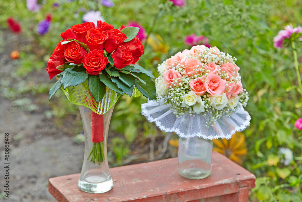 Two Wedding bouquets on a green abstract background in the garde Two Wedding bouquets on a green abstract background in the garde