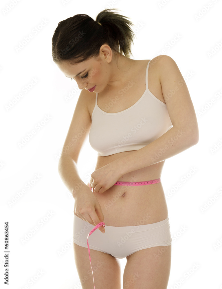 Obraz premium Slender young woman measuring her waist