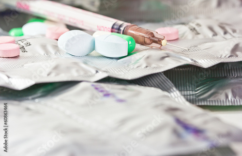 pills with syring on table