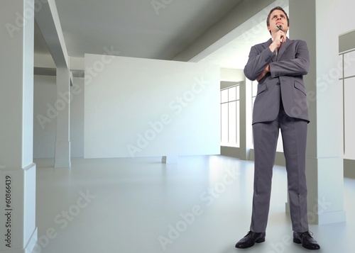 Wallpaper Mural Composite image of thinking businessman holding glasses Torontodigital.ca