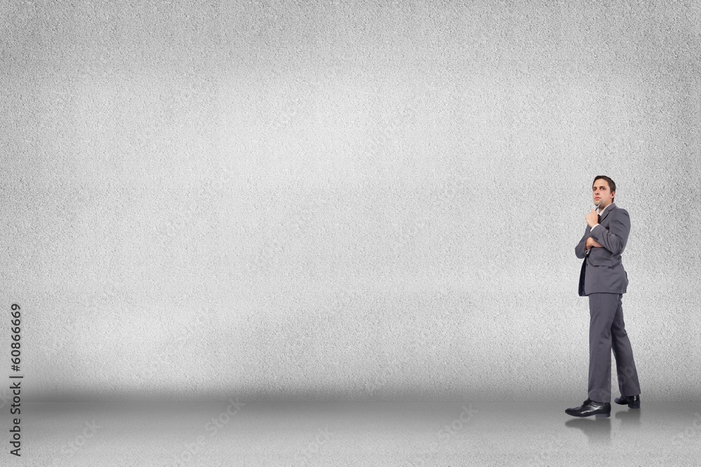 Composite image of thoughtful businessman holding pen to chin Composite image of thoughtful businessman holding pen to chin