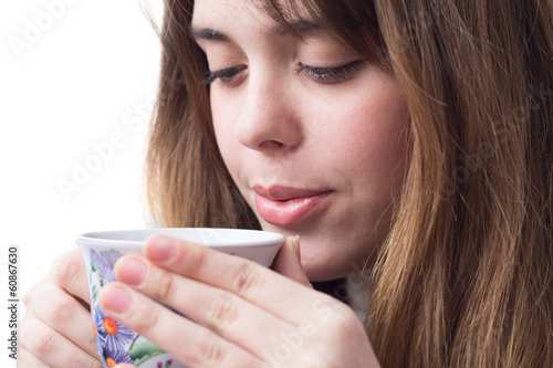 portrait of a beautiful girl with a cup of tea in her hands