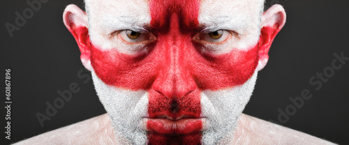Man with his face painted with the flag of England.