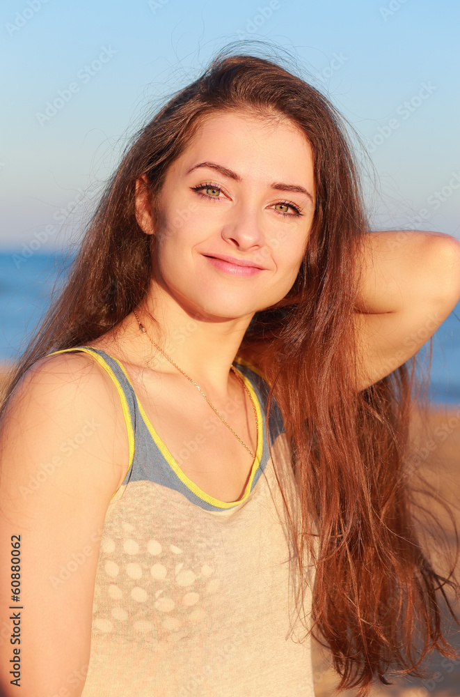 Beautiful relaxing woman looking happy on the beach