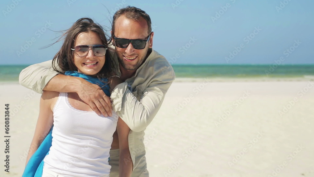 Happy couple standing on beautiful exotic beach Happy couple standing on beautiful exotic beach