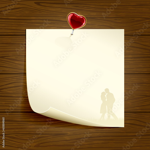 Paper with heart on wooden background